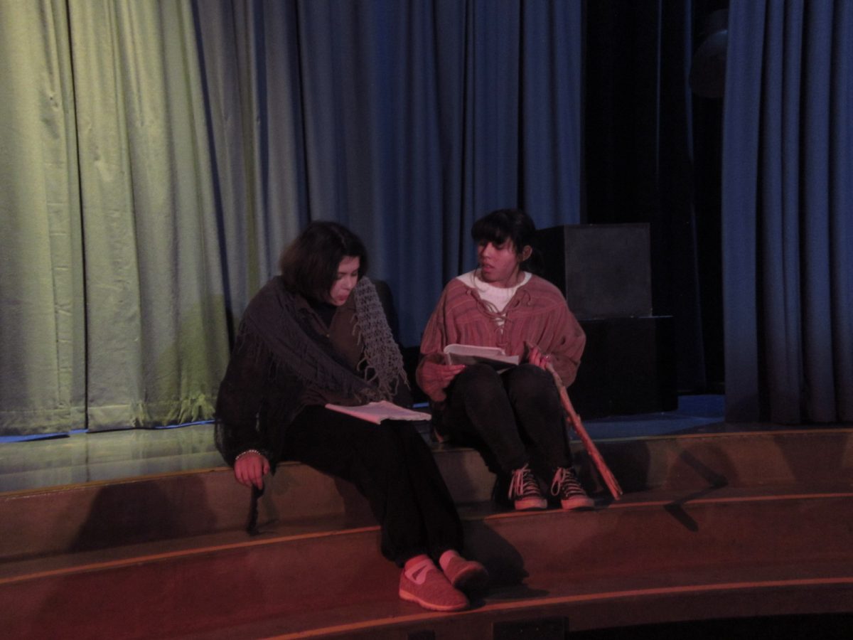 Caliban (played by Arianna Zalzalah) pictured left discussing with Stephano (played by Zaira Rodriguez) pictured right, on a murder plot against Prospero.