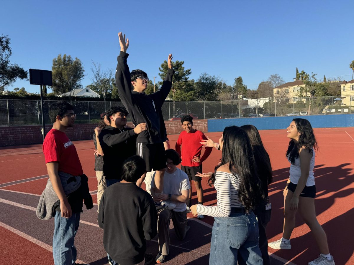 Powderpuff cheerleaders practice cheerleading.