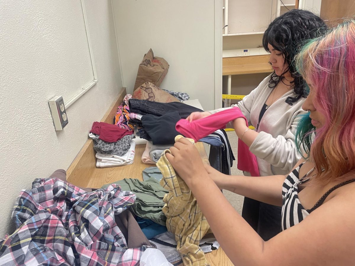 Community Closet Volunteers work to sort donated clothing. 